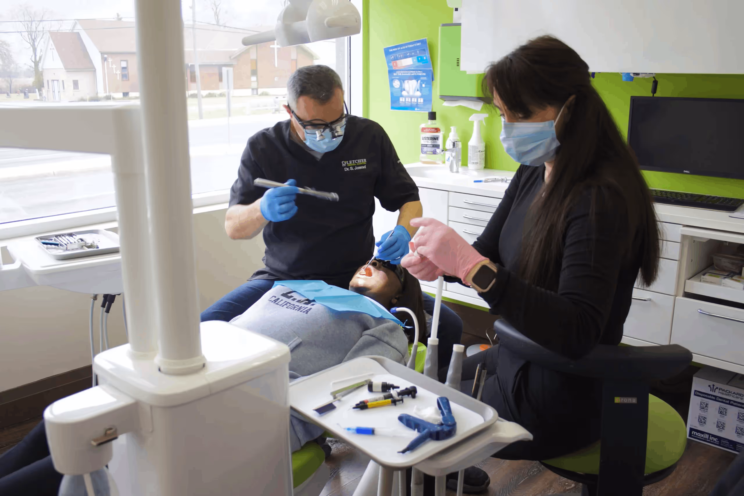 Dentist and assistant treating a patient at Fletcher Dental Centre